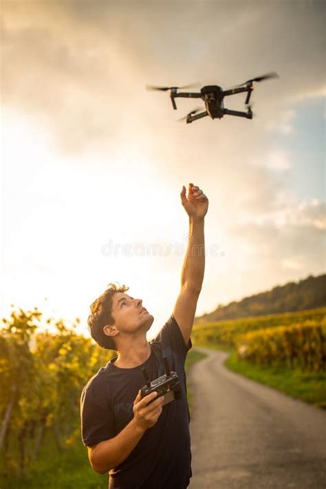 Young man flying a drone stock image. Image of shore - 172887583