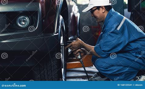 Car Mechanic in Uniform at Garage and Service Station Checking and ...