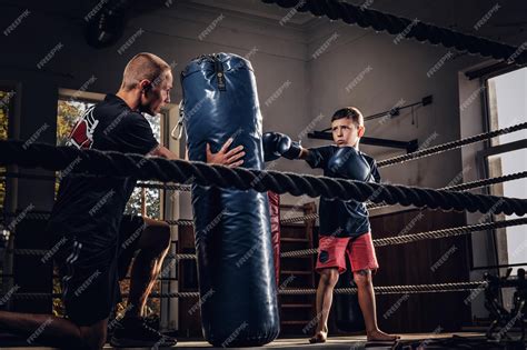 Free Photo | Little child have a serious boxing training with trainer ...