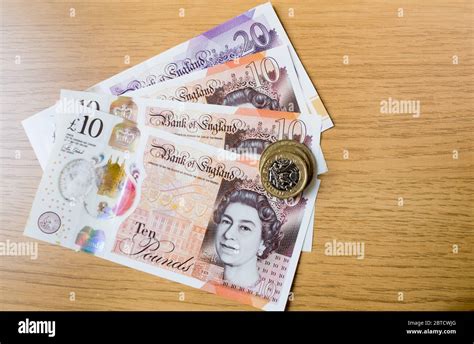 British pound currency polymer notes and coins Stock Photo - Alamy