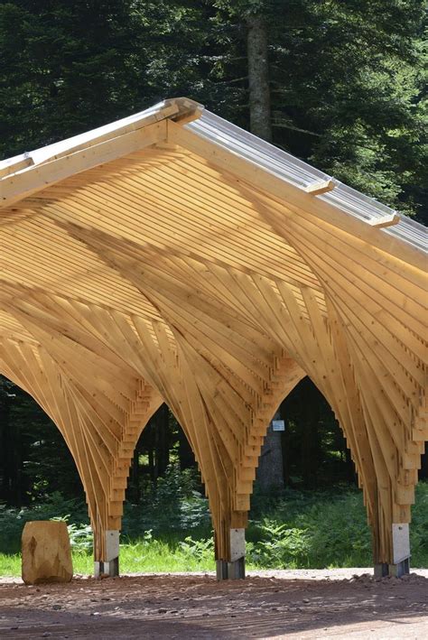 a large wooden structure sitting in the middle of a forest