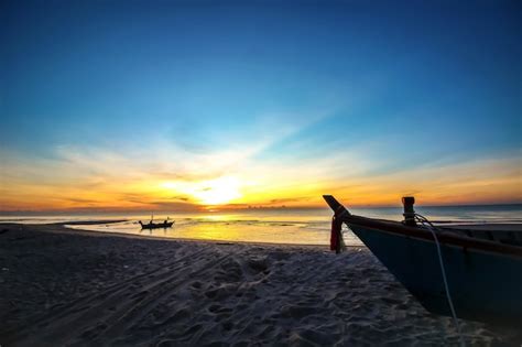 Premium Photo | Beautiful sunset sunrise on the beach with silhouette boat