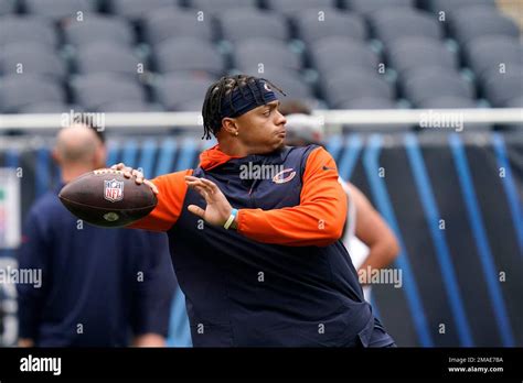 Chicago Bears quarterback Justin Fields warms up before an NFL football ...