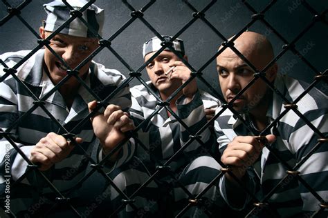 Three prisoners. Group of men in suits of convicts. Stock Photo | Adobe ...