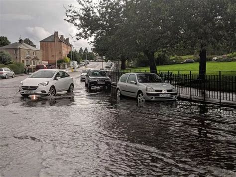 Edinburgh flooding: Watch as cyclist braves deep water, trains are stranded and cars float in ...