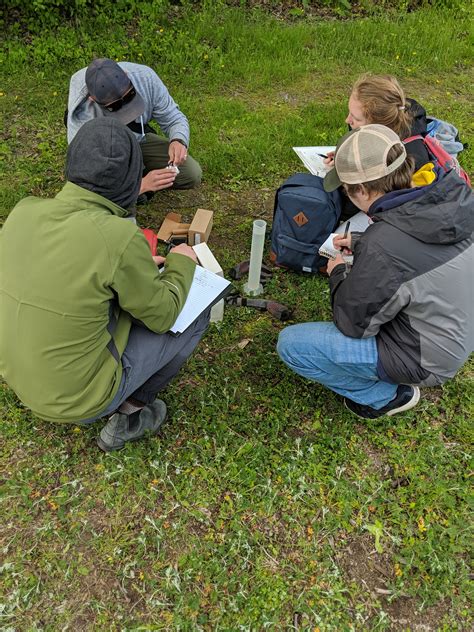 DGES alumni helping students learn hydrology field techniques - Geography and Environmental Studies