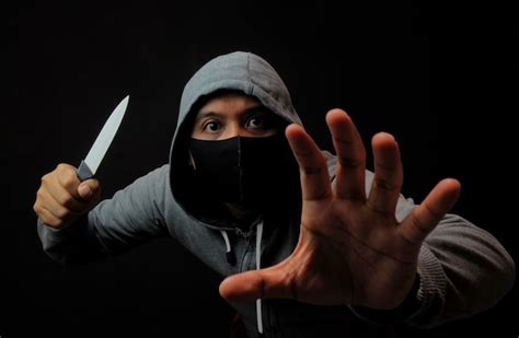 Premium Photo | Close up man holding knife in the dark