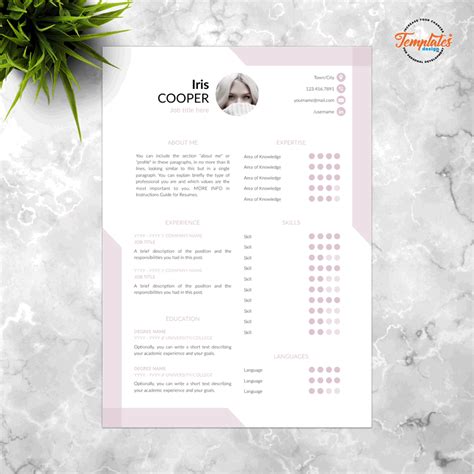 a pink and white resume template on a marble surface with a plant in the background