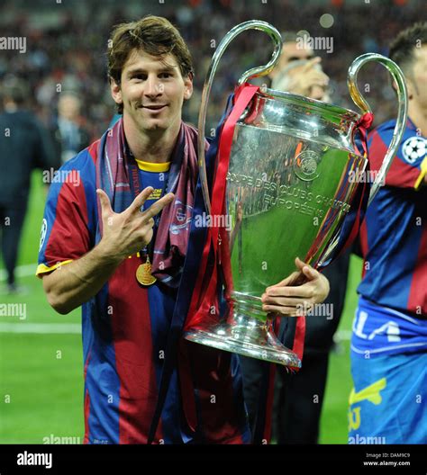 Barcelona's Lionel Messi holds the Champions League trophy after the Champions League Finale ...