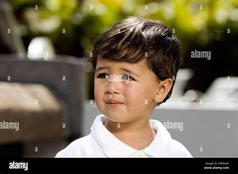 Close-up of a boy looking sad Stock Photo - Alamy