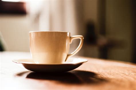 White Ceramic Teacup With Saucer on Wooden Table · Free Stock Photo
