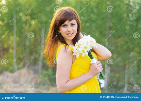 Happy Young Girl Smiling with a Bouquet of Flowers Outdoors Stock Photo ...