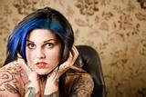 Image 1109148: Pretty Woman with Tattoos in a Leather Chair from Crestock Stock Photos