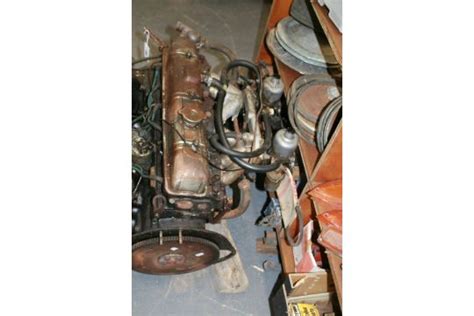 A Triumph 2500 engine. A Triumph dashboard and a large collection of miscellaneous parts and auto