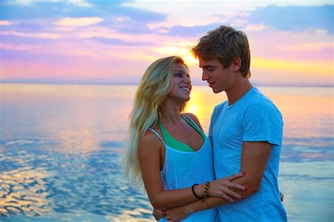 Premium Photo | Blond young couple hug in sunset sea lake happy