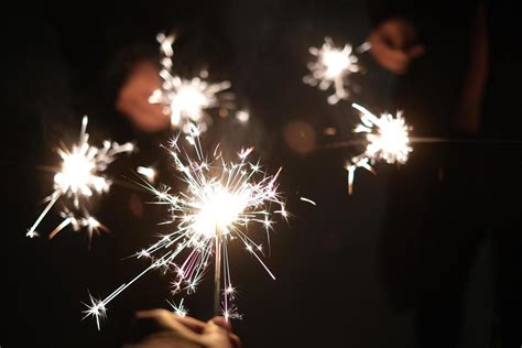 Friends holding fairy stick fireworks 21035307 Stock Photo at Vecteezy