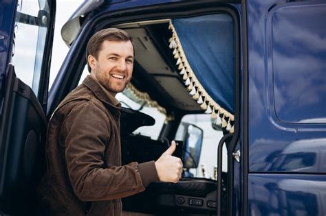 Premium Photo | Truck driver standing by his lorry