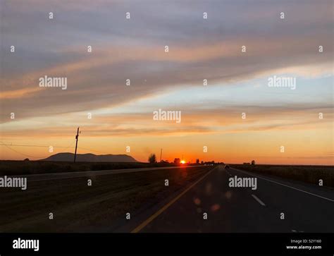 Sunset, mountain and road Stock Photo - Alamy