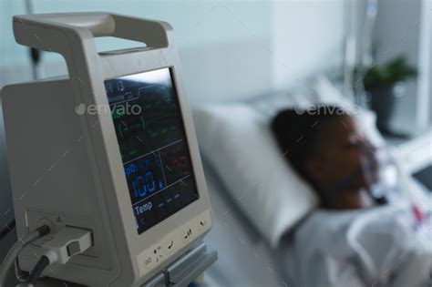 Patient monitoring device next to african american female patient lying ...