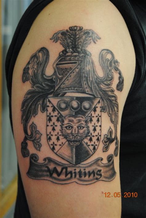 Beautiful gray ink family crest tattoo on half sleeve - Tattooimages.biz