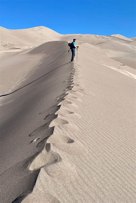 Sandboarding in Colorado (Great Sand Dunes) - Champagne Tastes®