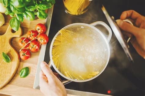 Free Photo | Man cooking pasta in boiling water