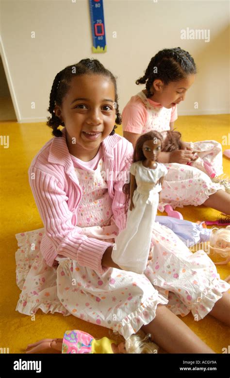 Girls playing with dolls hi-res stock photography and images - Alamy