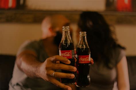 Close-Up Photography of People Holding Coca-Cola Bottles · Free Stock Photo