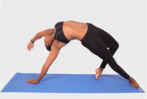 Woman doing yoga pose on blue yoga mat