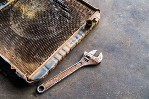 Premium Photo | Old radiator with wrench, repair