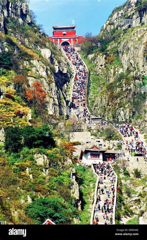 Tourists climb Mountain Tai or Taishan Mountain in snow in TaiAn city ...