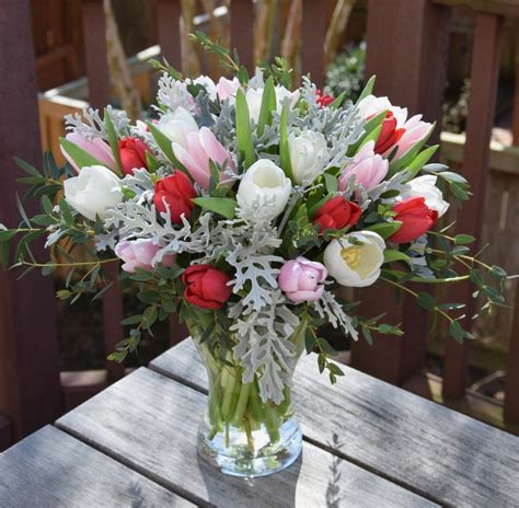 Flower arrangement with tulips and dusty miller | Fresh flowers arrangements, Flower ...