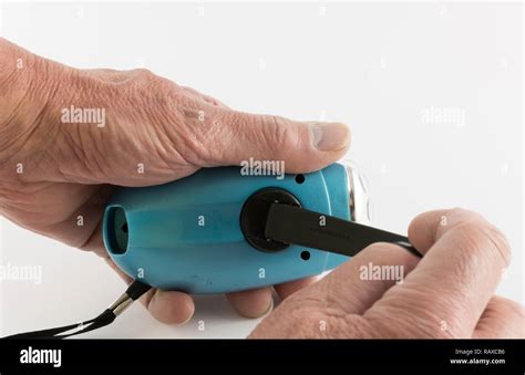 Wind up torch and hands Stock Photo - Alamy