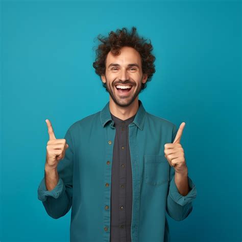 Premium AI Image | A man with a green shirt is pointing up with a green background