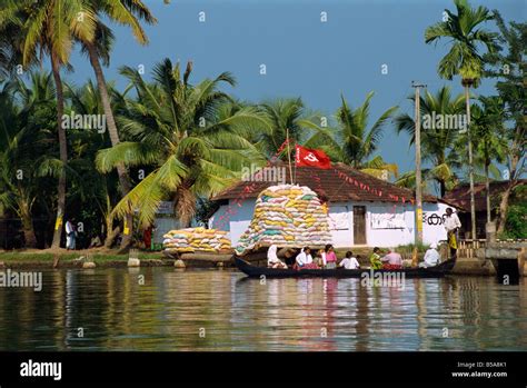 Small boat passing Communist flag, Backwaters, Kerala state, India ...