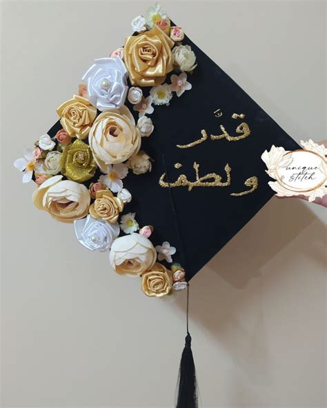 a graduation cap decorated with flowers and writing in gold foil on it ...