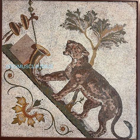 a mosaic with a monkey on it's back and a tree in the background