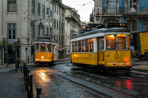 Yellow Trams - Lisbon - Two yellow trams pass in the early morning ...