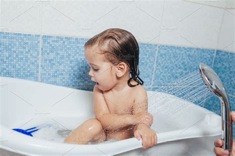 Beautiful little girl taking a bath stock photo containing bathtub and ...