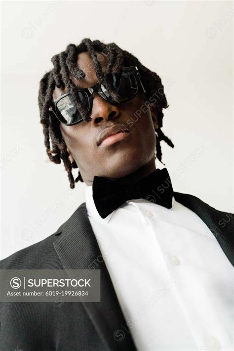 Portrait of the black man with dreadlocks wearing a suit with su ...