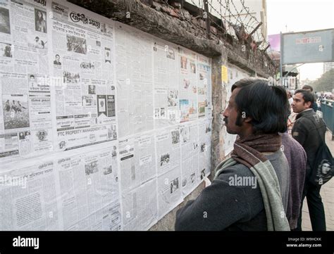 Dhaka, Bangladesh/ India July 24 2019 - Daily newspaper on the wall in the streets of Dhaka ...