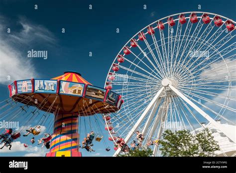 Flying chair and ferris wheel ride on an amusement center Stock Photo ...