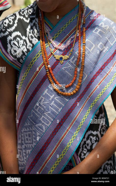 TIMOR LESTE Girl wearing traditional dress including ikat weaves and ...