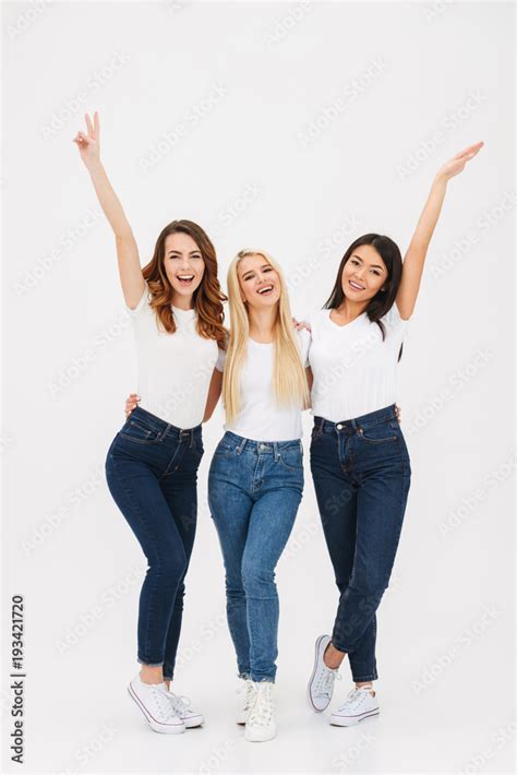 Portrait of three cheerful casual girls standing together Stock Photo ...