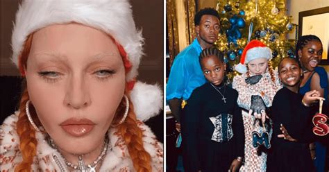 Madonna poses in Santa hat in front of Christmas tree as she spends ...