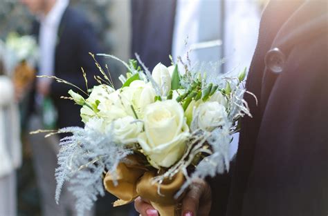 Person Holding Bouquet of White Roses · Free Stock Photo