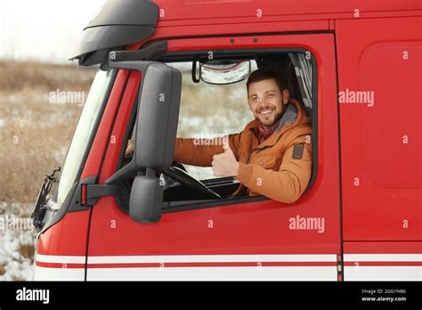 Young man driving big modern truck Stock Photo - Alamy