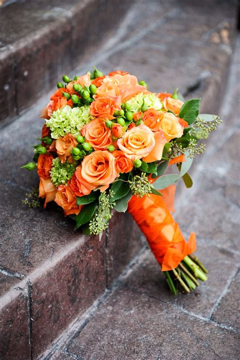 an orange bridal bouquet sitting on the steps
