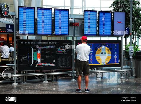 An adult man absorbs the information screens presented to him about arrivals, departures and the ...