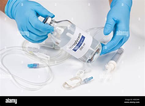 Nitroglycerin bottle held by nurse with iv tubing Stock Photo, Royalty Free Image: 128772719 - Alamy